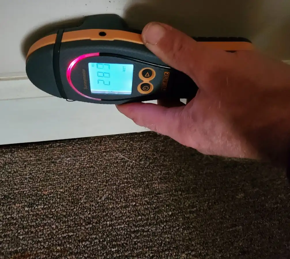 Moisture detection at baseboard during Storm Damage Restoration in Piney Green